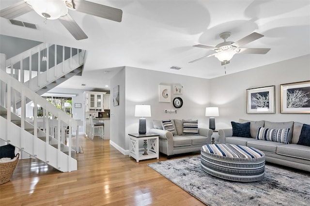 living room with hardwood / wood-style floors and ceiling fan