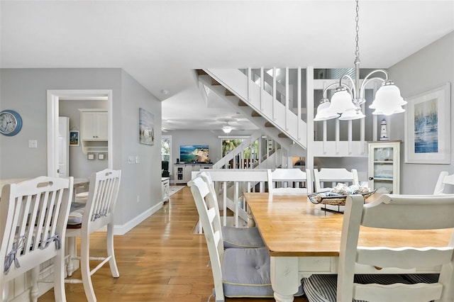 dining room with wood-type flooring and a notable chandelier