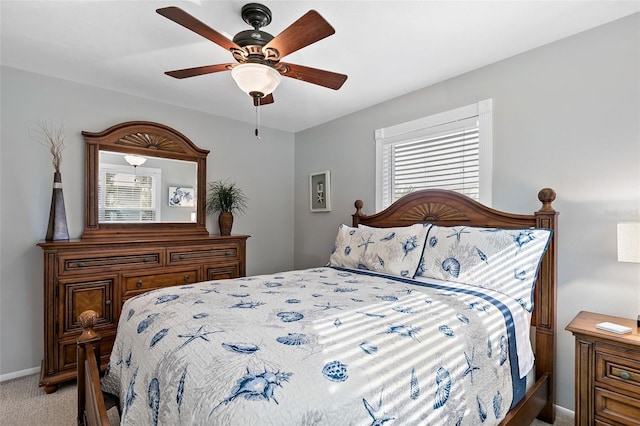 carpeted bedroom with multiple windows and ceiling fan