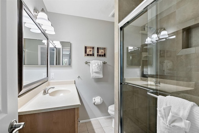 bathroom with toilet, vanity, tile patterned floors, and walk in shower