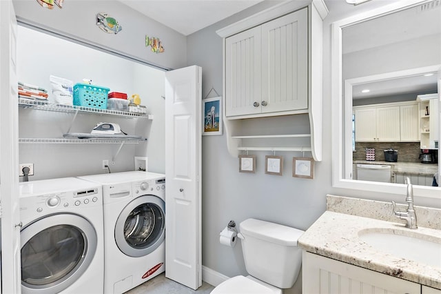 clothes washing area featuring washer and dryer and sink