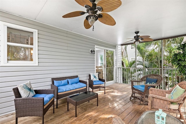 sunroom / solarium featuring ceiling fan