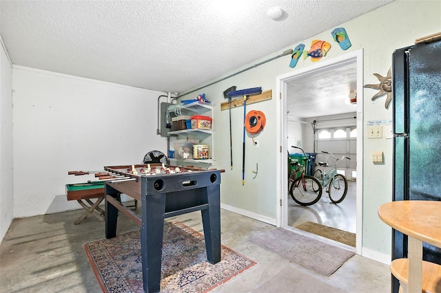 rec room featuring concrete flooring and a textured ceiling