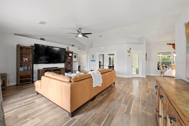 living room with ceiling fan, light hardwood / wood-style floors, and lofted ceiling