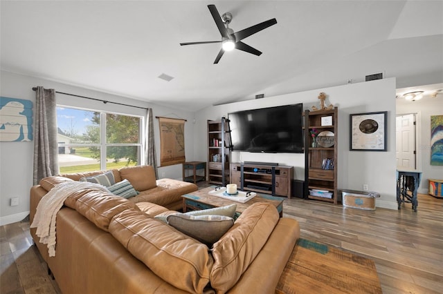 living room featuring dark hardwood / wood-style floors, vaulted ceiling, and ceiling fan