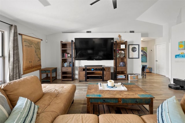 living room featuring ceiling fan, light hardwood / wood-style floors, and vaulted ceiling