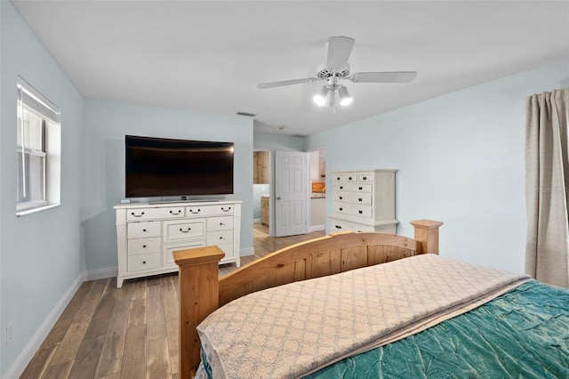 bedroom featuring ceiling fan, wood-type flooring, and connected bathroom