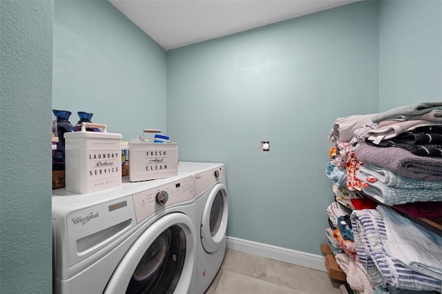 laundry area featuring separate washer and dryer and light tile patterned flooring