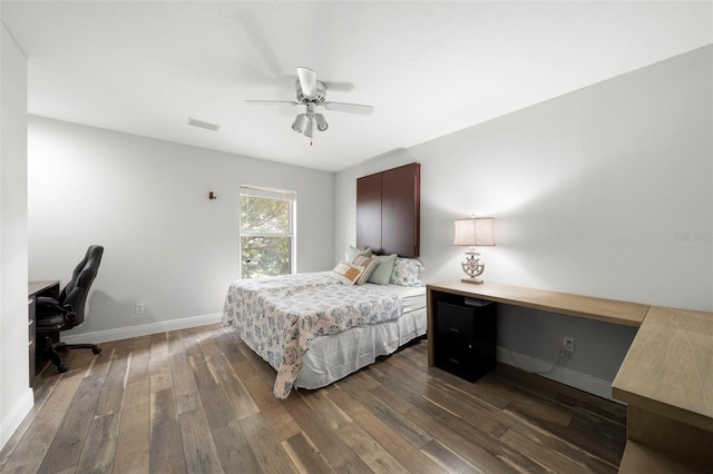 bedroom with ceiling fan, dark hardwood / wood-style flooring, and built in desk