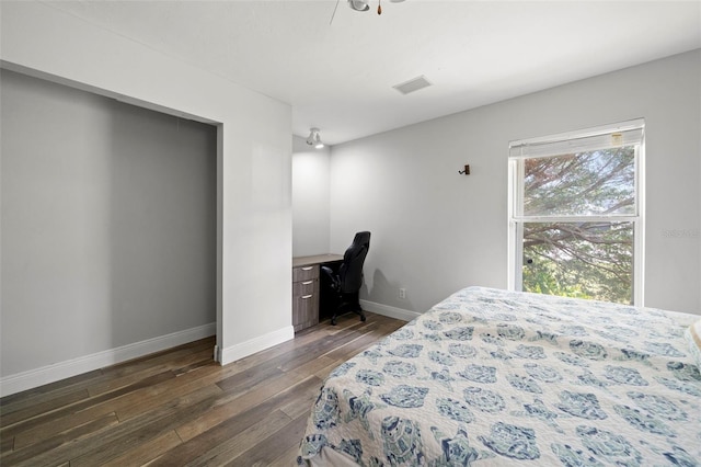 bedroom with dark hardwood / wood-style floors