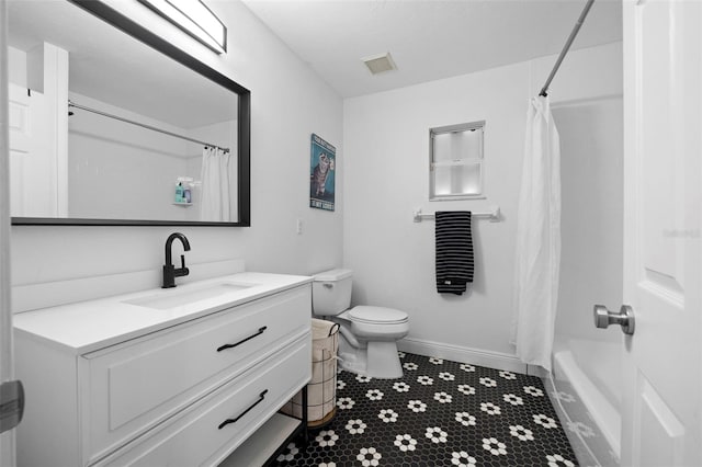 full bathroom featuring shower / bath combination with curtain, vanity, and toilet