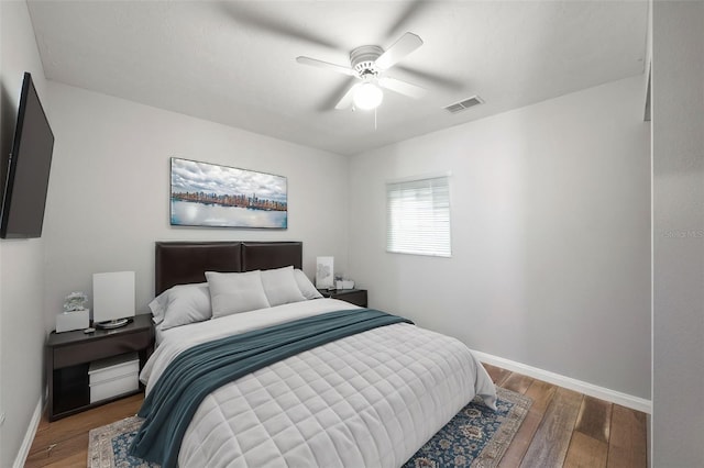 bedroom featuring ceiling fan and dark wood-type flooring