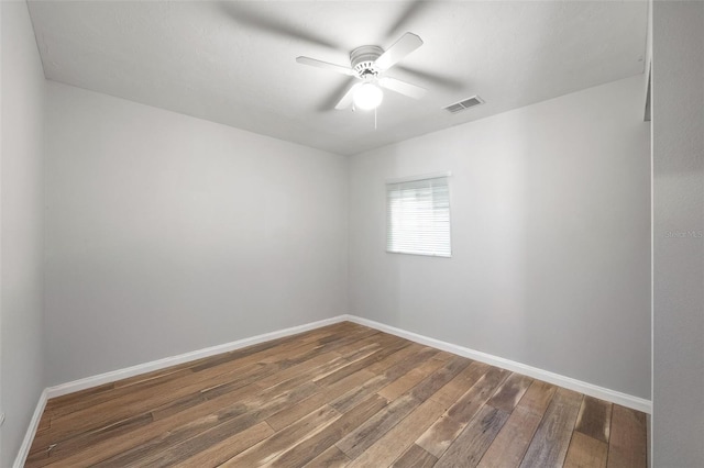 spare room with ceiling fan and dark hardwood / wood-style floors