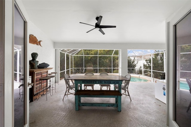 sunroom / solarium with ceiling fan and a swimming pool