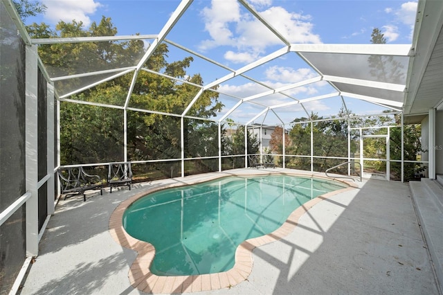 view of pool with a patio and glass enclosure