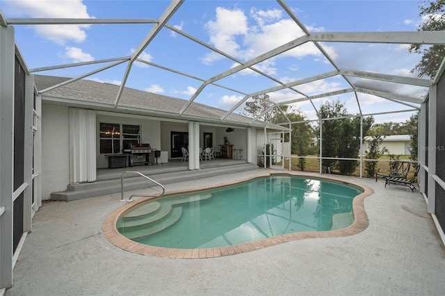 view of swimming pool with a patio, area for grilling, and a lanai