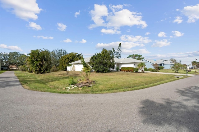 view of front of property featuring a front yard and a garage