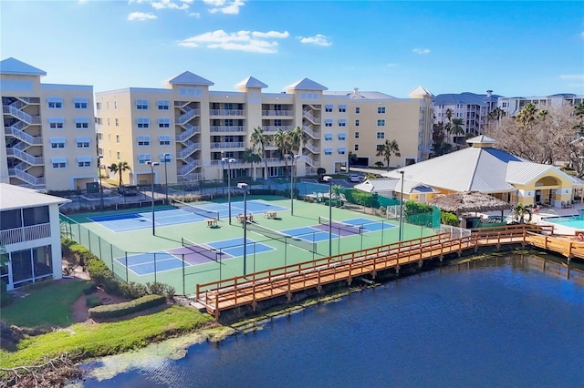 view of tennis court featuring a water view