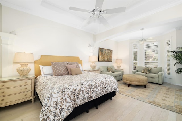 bedroom with ceiling fan, a raised ceiling, wood finished floors, and ornamental molding