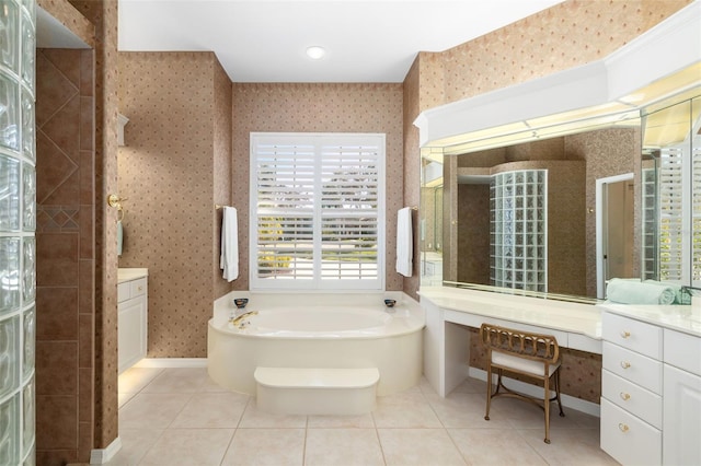 bathroom with tile patterned floors, vanity, and shower with separate bathtub