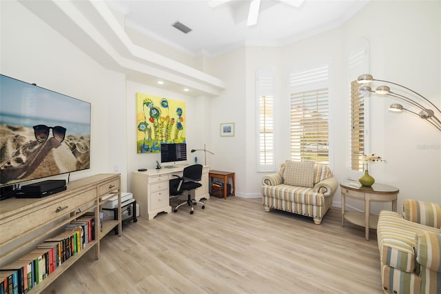 office featuring light wood finished floors, visible vents, crown molding, baseboards, and a ceiling fan