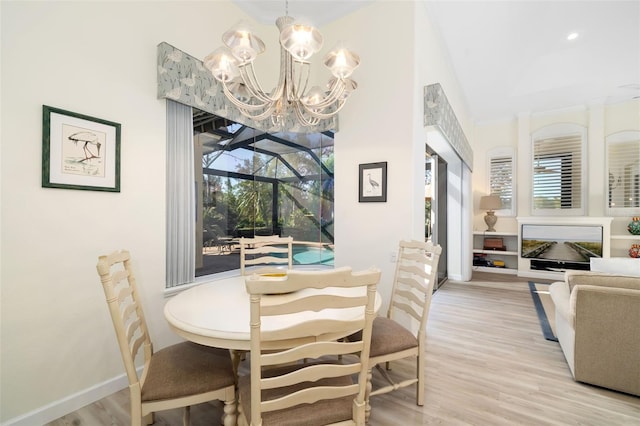 dining area with an inviting chandelier and light hardwood / wood-style flooring