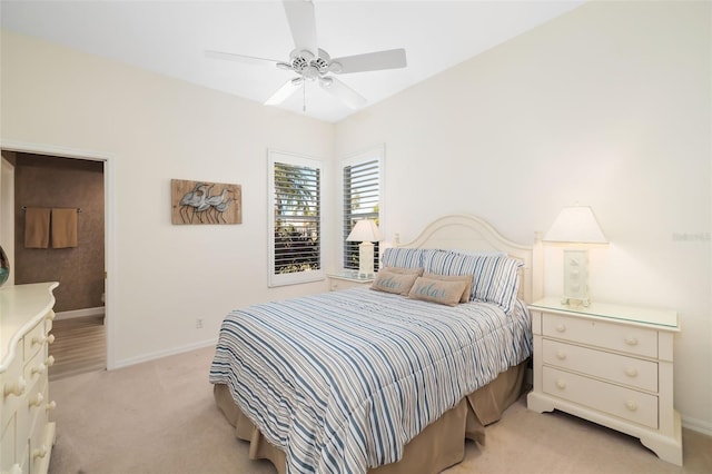 bedroom with light colored carpet, baseboards, and ceiling fan