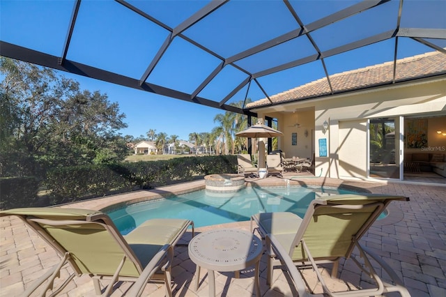 view of pool featuring an in ground hot tub, a patio, and glass enclosure