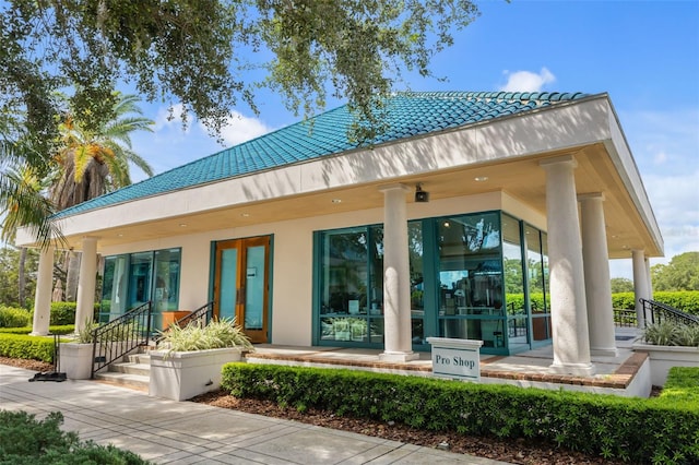 rear view of property featuring covered porch