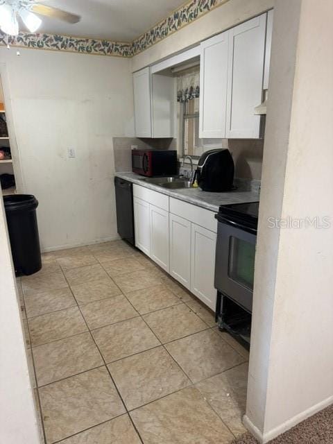 kitchen with black appliances, ceiling fan, white cabinets, and sink