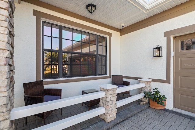 entrance to property with a garage and stucco siding