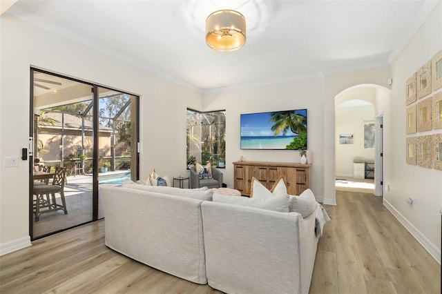 living room with light hardwood / wood-style floors and ornamental molding