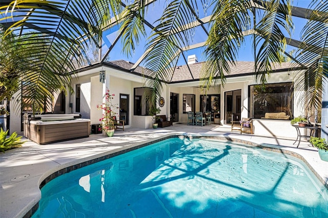 view of pool with a patio area, a jacuzzi, ceiling fan, and glass enclosure