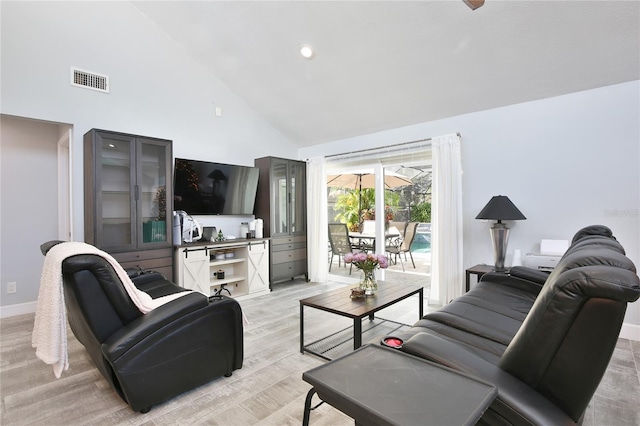 living room featuring light hardwood / wood-style floors and high vaulted ceiling