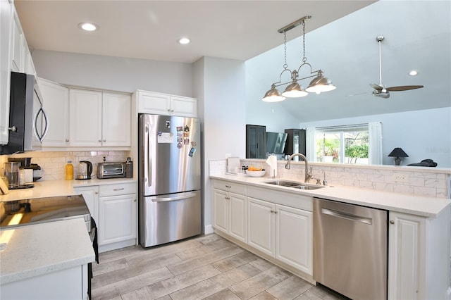 kitchen with appliances with stainless steel finishes, white cabinetry, and sink