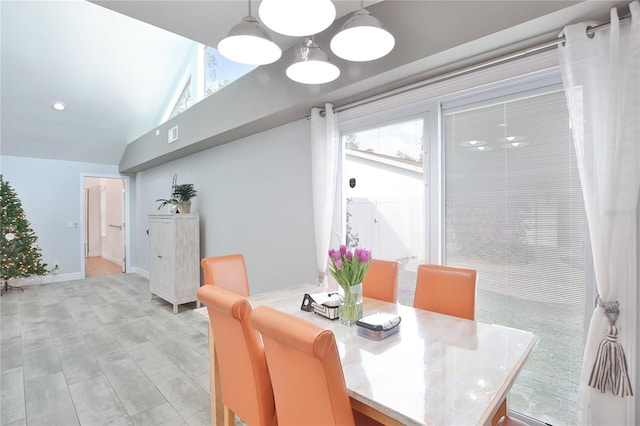 dining room featuring a chandelier and lofted ceiling