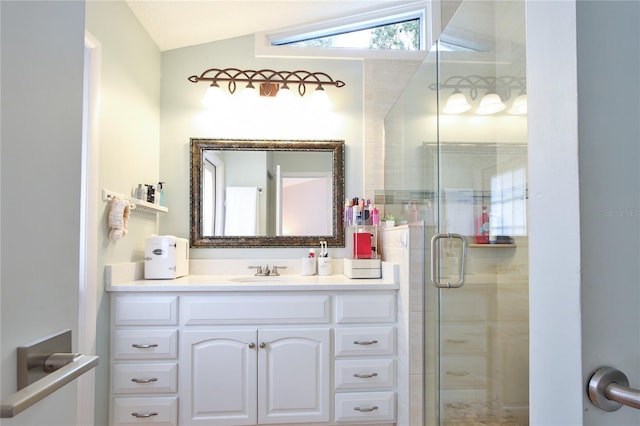 bathroom with vanity, a shower with shower door, and lofted ceiling