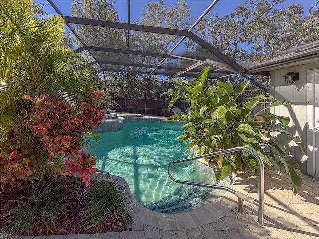 view of swimming pool featuring a lanai