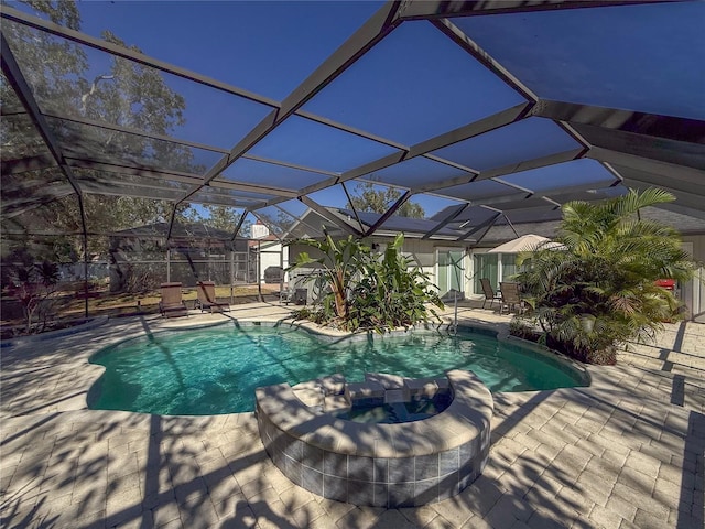 view of pool with a patio and glass enclosure