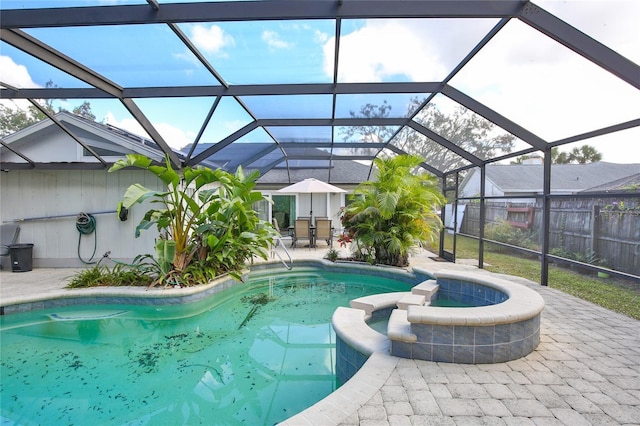 view of pool featuring a lanai, an in ground hot tub, and a patio