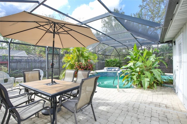 view of patio featuring glass enclosure and a pool with hot tub