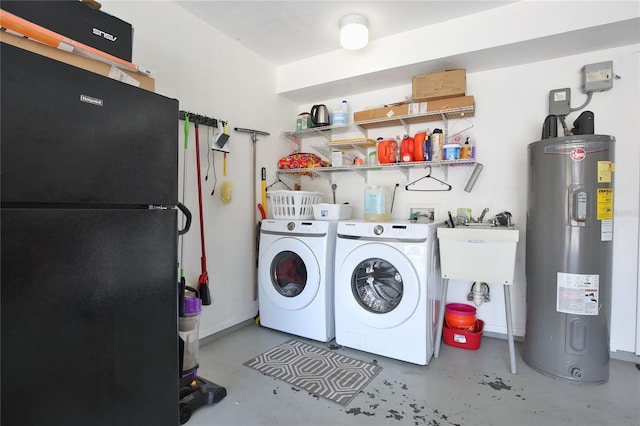 clothes washing area with separate washer and dryer and water heater