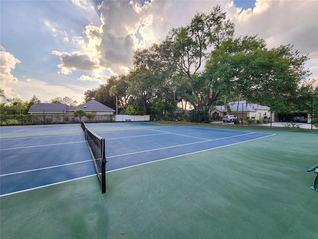 view of tennis court with basketball hoop