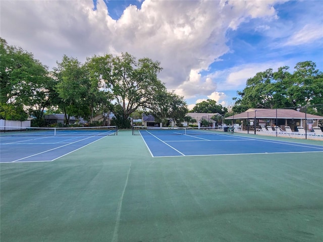 view of tennis court featuring basketball hoop