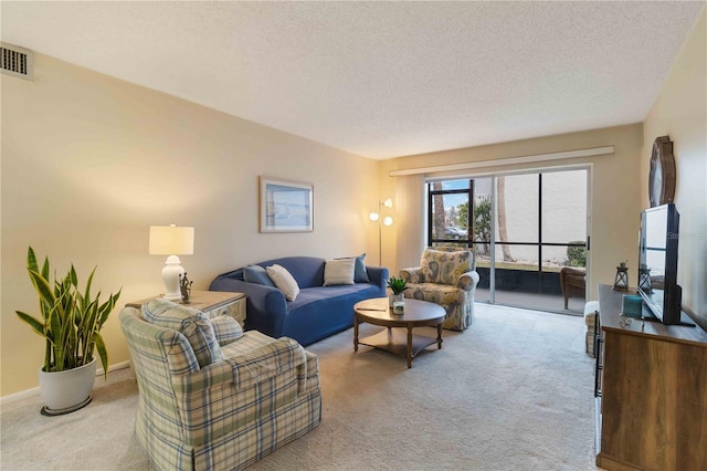 living room with light colored carpet and a textured ceiling