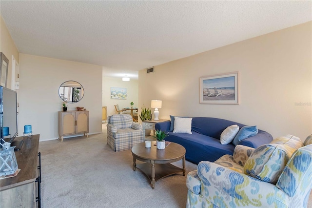 living room featuring light colored carpet and a textured ceiling