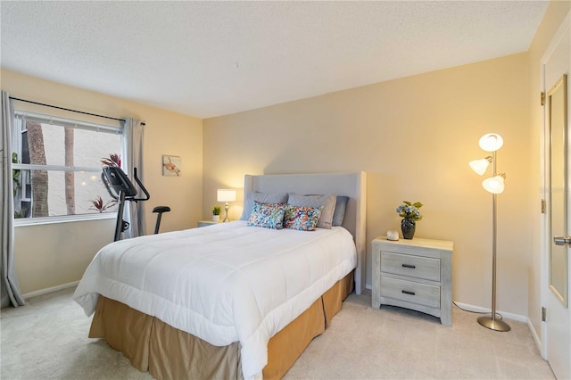 bedroom featuring a textured ceiling and light carpet