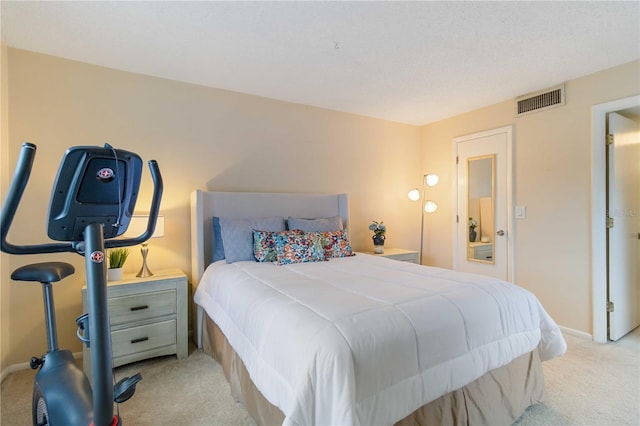 bedroom featuring light carpet