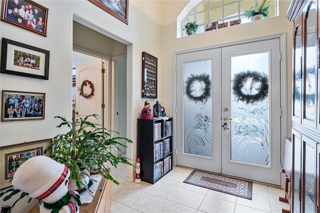 foyer with french doors and light tile patterned flooring