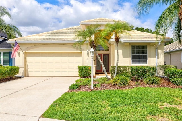 8412 Whispering Woods Ct, Lakewood Ranch, FL 34202 - view of front of house with a tiled roof, a garage, stucco siding, and driveway